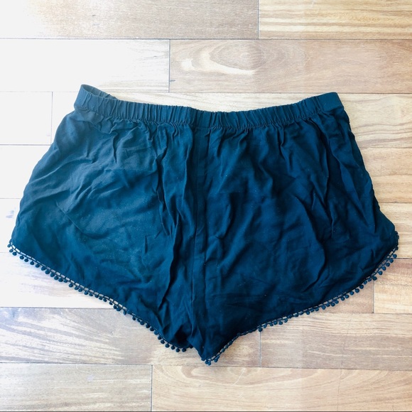 Express Pants - Black short shorts with tiny tassel detail